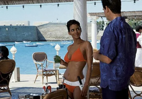 Halle Berry in an orange bikini walking out of the ocean in Die Another Day (2002)