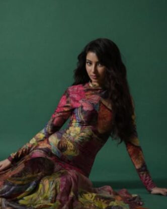 Sara Arjun posing in a patterned outfit during a studio fashion photoshoot
